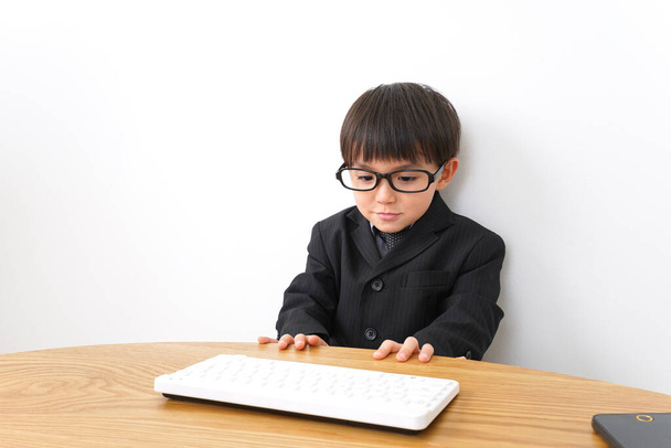 little boy wearing suit studying - Photo, Image