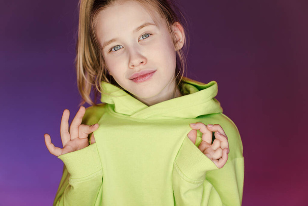 Young stylish girl in the Studio on a colored neon background. Music dj poster design. Portrait of a young girl dancer. - Photo, Image