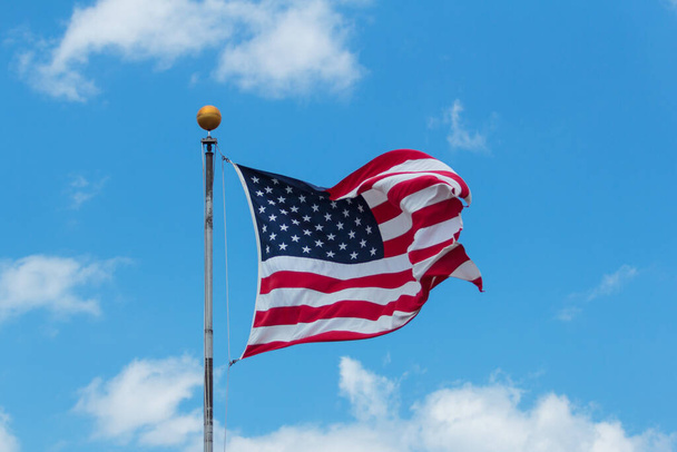 American flag against blue sky. - Фото, зображення