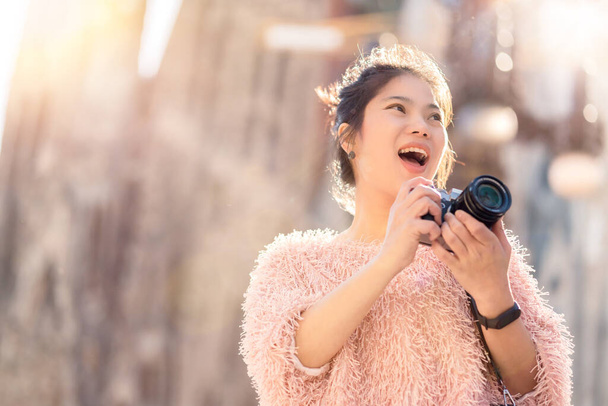 happy travel closeup asian woman hand sshoot camera traveller capture memory with background of famous landmark architecture,asian photographer travel with camera vacation concept - Fotó, kép