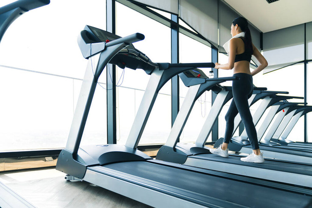 beautiful asian healthy sport woman workout run on treadmill in gym - Photo, Image