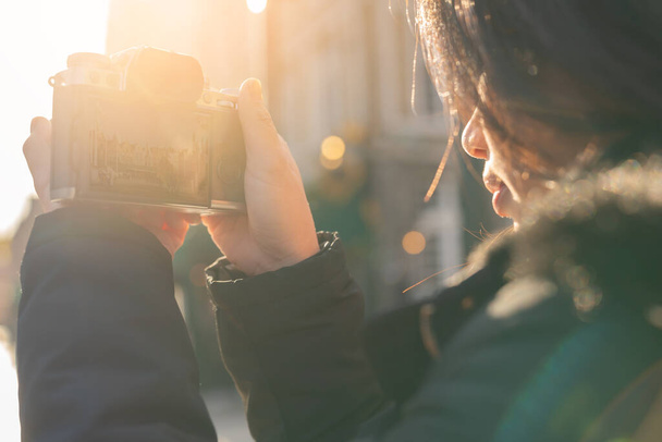 closeup asian woman hand hold retro camera traveller with background of old tradition architecture,asian photograper travel with retro camera - Photo, Image
