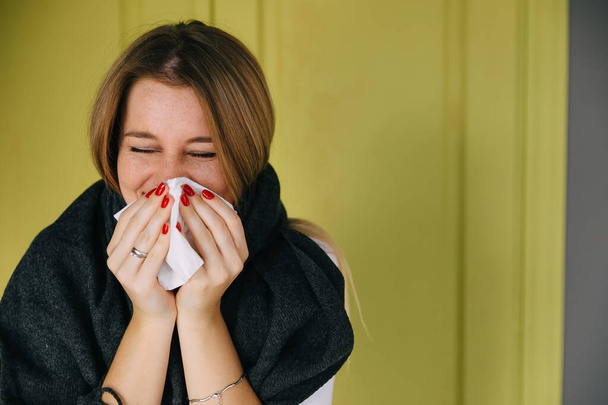 Sick caucasian girl on green background use handkerchief blow nose suffering from flu, unhealthy ill woman with paper tissue having runny nose, catch cold, need medication - Photo, Image