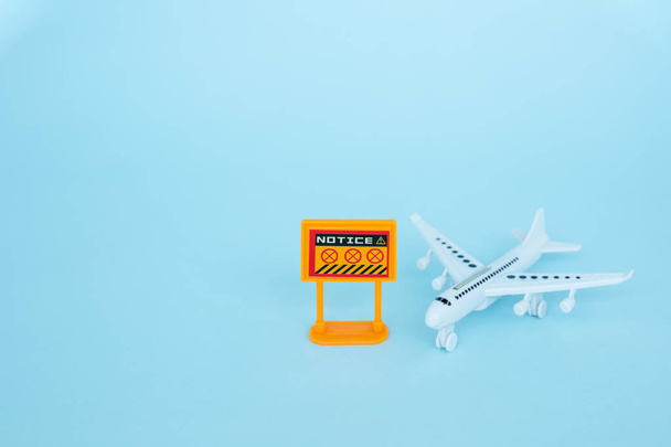 White airplane model with prohibition sign on blue background for vehicle and transportation in coronavirus or Covid-2019 situation concept - Photo, Image