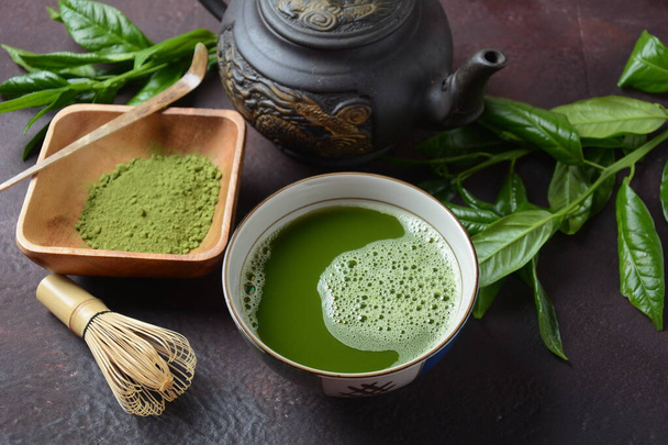 Green matcha tea drink and tea accessories on white background. Japanese tea ceremony concept. Detox tea. Antioxidant drink - Photo, Image