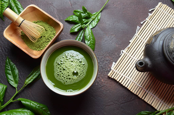 Green matcha tea drink and tea accessories on white background. Japanese tea ceremony concept. Detox tea. Antioxidant drink - Photo, Image