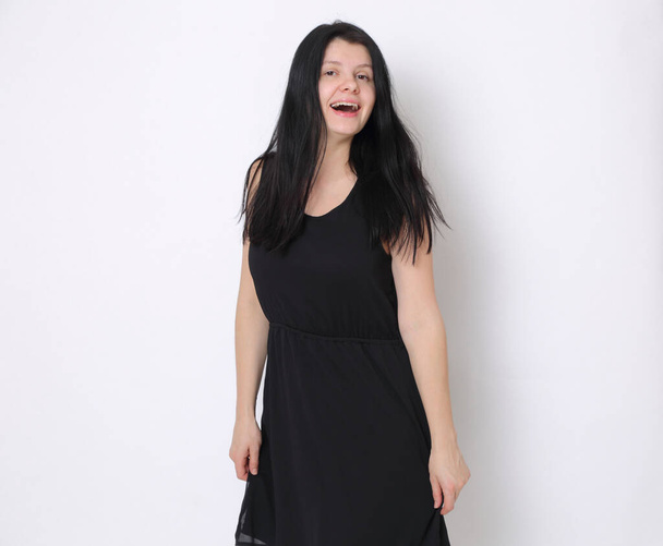 Caucasian woman in elegant small black dress/Joyful woman posing on camera - Foto, Bild