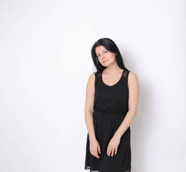 Caucasian woman in elegant small black dress/Joyful woman posing on camera - Фото, изображение