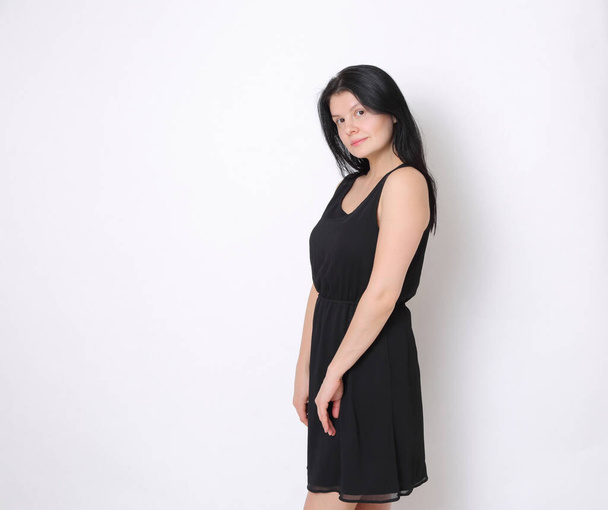 Caucasian woman in elegant small black dress/Joyful woman posing on camera - Foto, Imagem