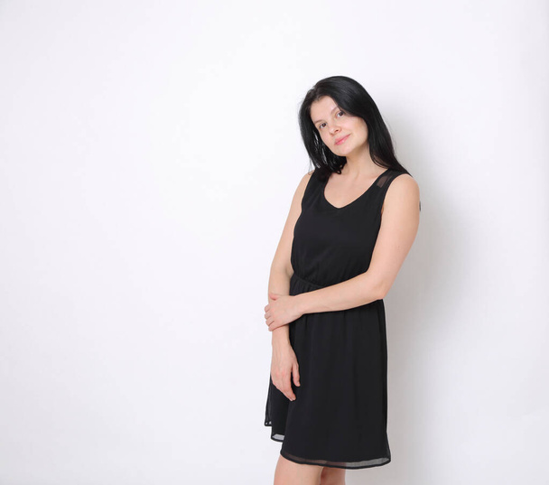 Caucasian woman in elegant small black dress/Joyful woman posing on camera - Fotografie, Obrázek