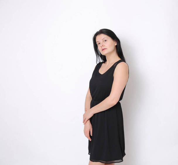 Caucasian woman in elegant small black dress/Joyful woman posing on camera - Foto, Imagen