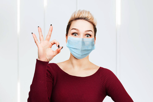 young woman sign ok, wearing protective face mask prevent virus infection, pollution. - Valokuva, kuva