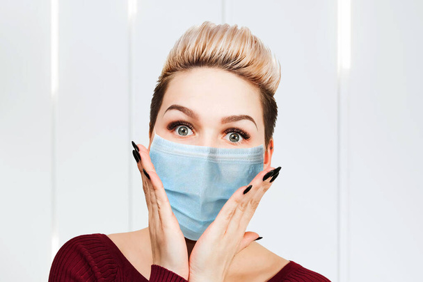 young woman amazed wearing protective face mask prevent virus infection, pollution. - Foto, afbeelding