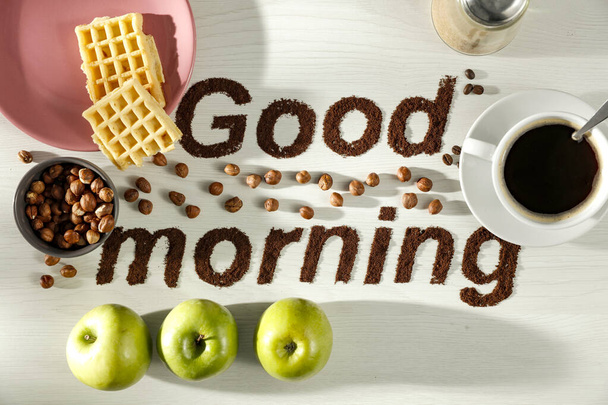 Good morning coffee grain beans inscription with bright table background. Copy space for advertising products and decoration. - 写真・画像