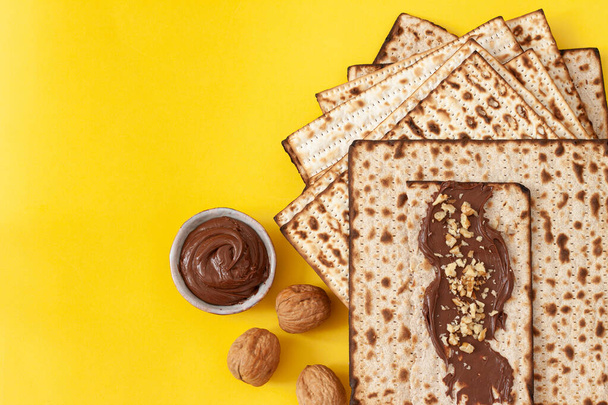 Jewish matzo sandwich with chocolate paste and walnuts on Passover. - Photo, Image