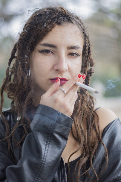 Portrait girl in madrid city with jacket black smoking - Фото, зображення