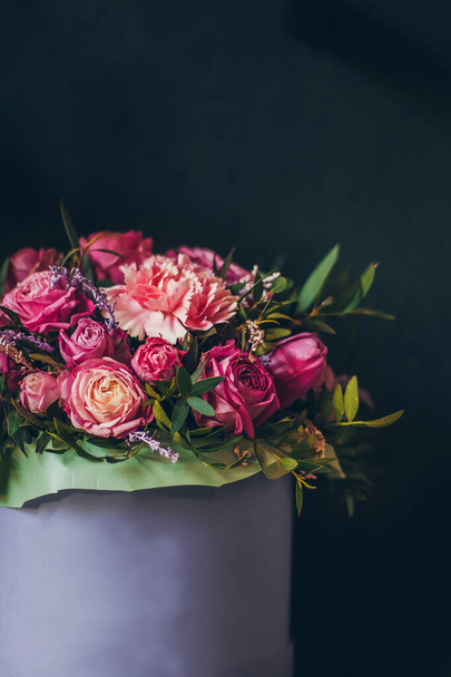 Still life with pink bouquet on the dark background. - Foto, afbeelding
