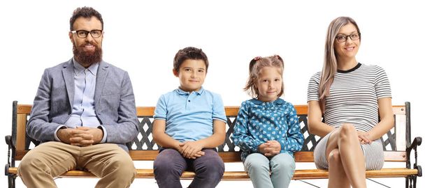 Parents and children sitting on a bench and looking at the camera isolated on white background - Φωτογραφία, εικόνα