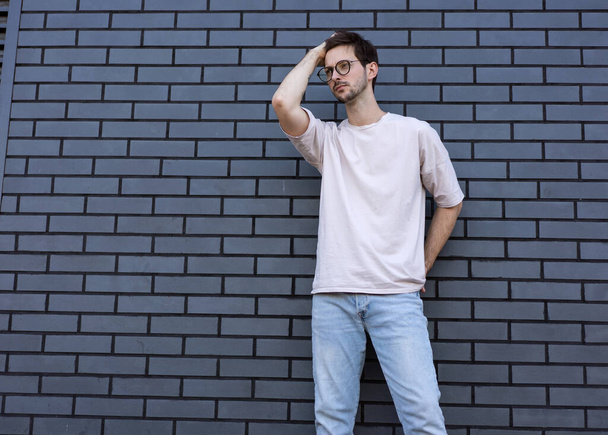 fashion guy  poses brick black urban background - Foto, imagen