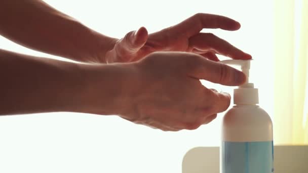 Mies tekee käden desinfioinnista antiseptistä. Alkoholipohjainen puhdistusaine, jota uutetaan miehen sormilla. Vähentää riskiä saada ja levittää infektio kuten sepelvaltimovirus COVID-19. Kädet hygienia
. - Materiaali, video