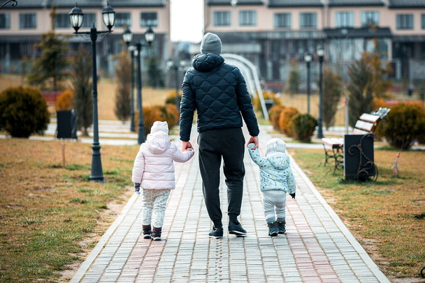father with children walks in the park - Valokuva, kuva