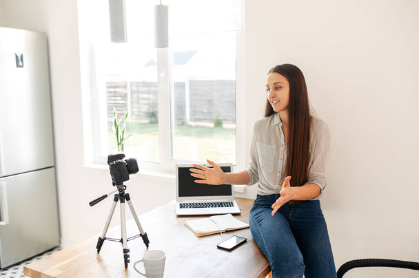 Young woman records video lessons on camera - Foto, afbeelding