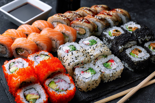 Sushi set, on a black background, five types of rolls - Photo, Image