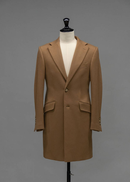 Beige coat on a mannequin in the studio - Zdjęcie, obraz