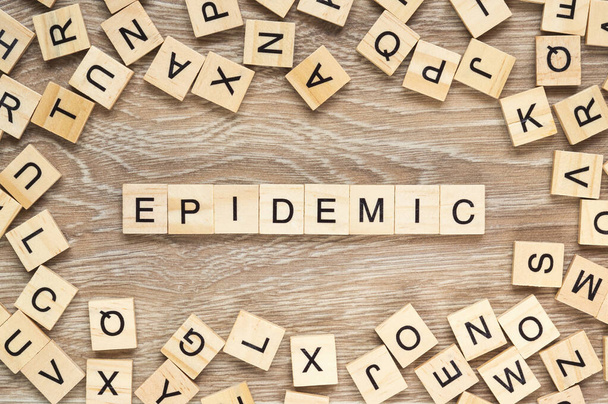 The word "Epidemic" spelt out with letter tiles on the wooden background - 写真・画像