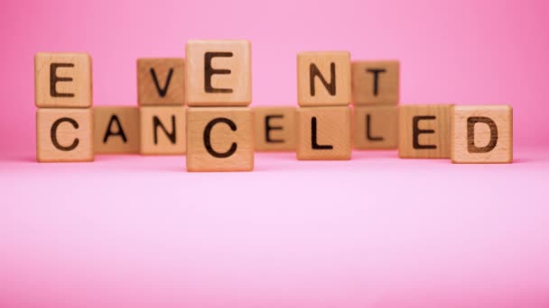 Event cancelled on wooden cubes. Cancelled word made with building blocks. Mass gathering cancelled. Repatriation and quarantine of travellers. Travel advice. Protect from coronavirus infection - Footage, Video