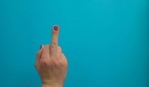 woman hand pointing up well, yes, taking hand sign aside, isolated on blue background. - 写真・画像