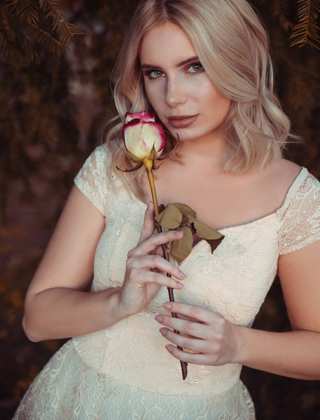 Portrait of young woman with rose flower - Φωτογραφία, εικόνα