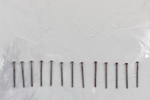 Old rusty nails on gray background - Foto, Bild