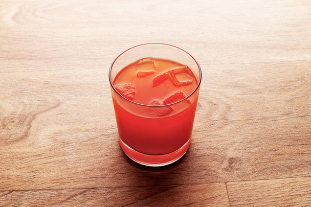 cocktail juice ice in a glass cup on a wooden background - Photo, image