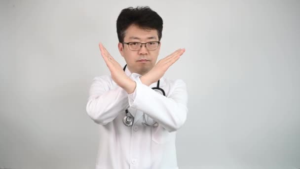 4K. Um médico asiático de meia-idade levanta a mão e expressa sua desaprovação
. - Filmagem, Vídeo