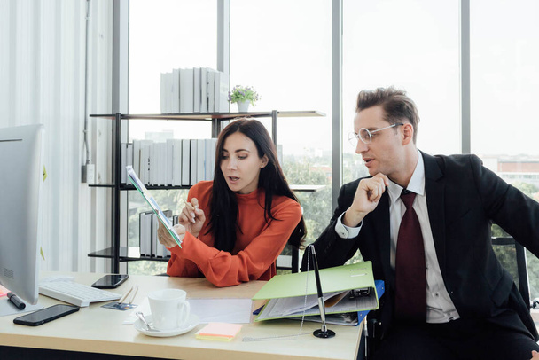 Two business people discussing about work in an office. - Photo, Image