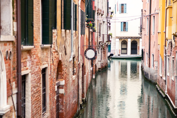 Picturesque Old Venice Canal with Red Buildings and Boat. Rainy Weather. - Photo, image