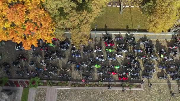 Group motorcycle bikers in town square, closing of the season, Lithuania, aerial  - Footage, Video