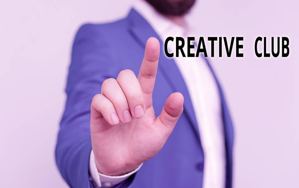 Writing note showing Creative Club. Business photo showcasing an organization that simulate interest in creative ideas Businessman blue suite and white shirt pointing with finger. - Photo, Image