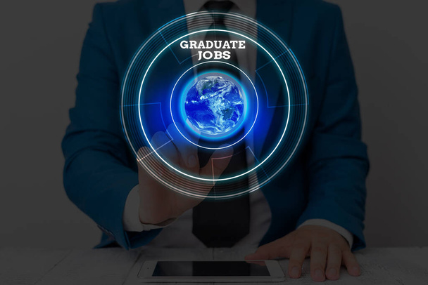 Text sign showing Graduate Jobs. Conceptual photo require someone to hold a degree to start their career Elements of this image furnished by NASA. - Photo, Image