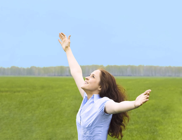 Curly redhead woman. happy smiling joyful with hands up dancing on field in summer during holidays. Beautiful young female model.Young woman outdoors.Freedom and springtime concept. - Foto, Bild
