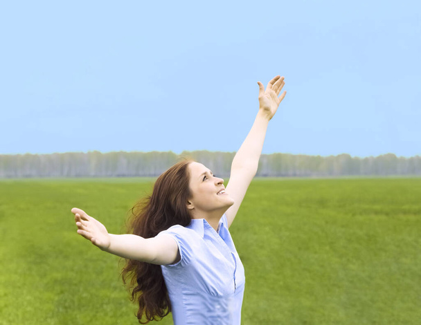 Curly redhead woman. happy smiling joyful with hands up dancing on field in summer during holidays. Beautiful young female model.Young woman outdoors.Freedom and springtime concept. - Foto, Imagen