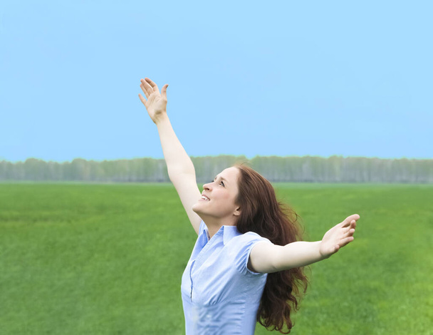 Curly redhead woman. happy smiling joyful with hands up dancing on field in summer during holidays. Beautiful young female model.Young woman outdoors.Freedom and springtime concept. - Foto, imagen