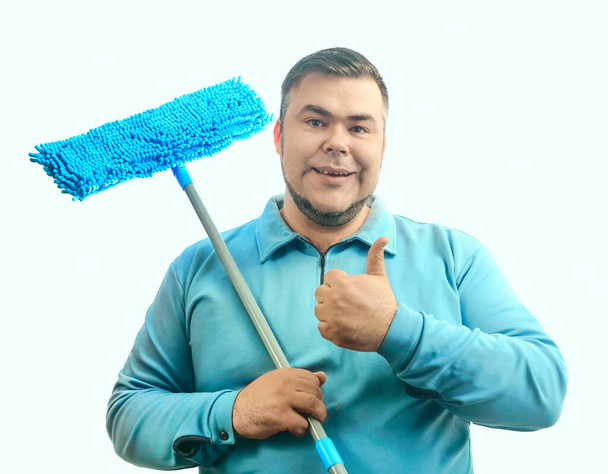 happy man holding mops for cleaning floor. middle age cleaning male.  cleaner with modern cleaning tool. Sanitation and cleaning service. isolated on white background. - 写真・画像