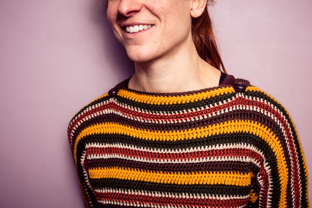 Smiling young woman in colorful jumper - Φωτογραφία, εικόνα
