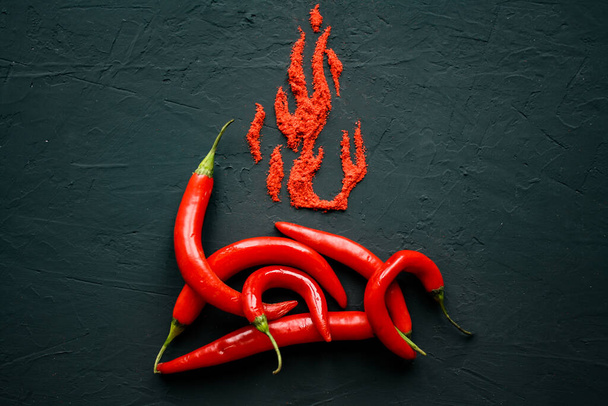 Red hot capsicum with paprika scattered in the form of flame petals - 写真・画像