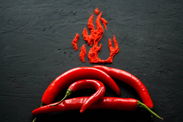 Red hot capsicum with paprika scattered in the form of flame petals - 写真・画像