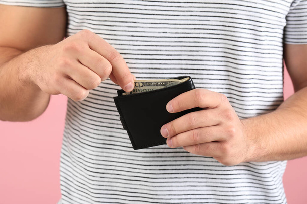 Man with purse on color background, closeup - Photo, Image