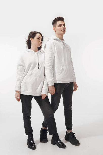 Trendy fashionable couple isolated on white studio background - Φωτογραφία, εικόνα