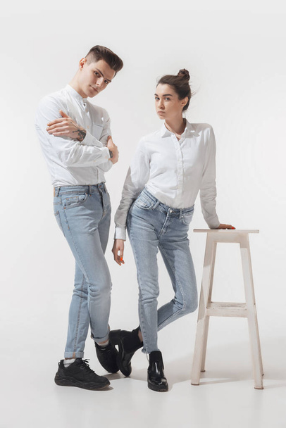 Trendy fashionable couple isolated on white studio background - Fotó, kép